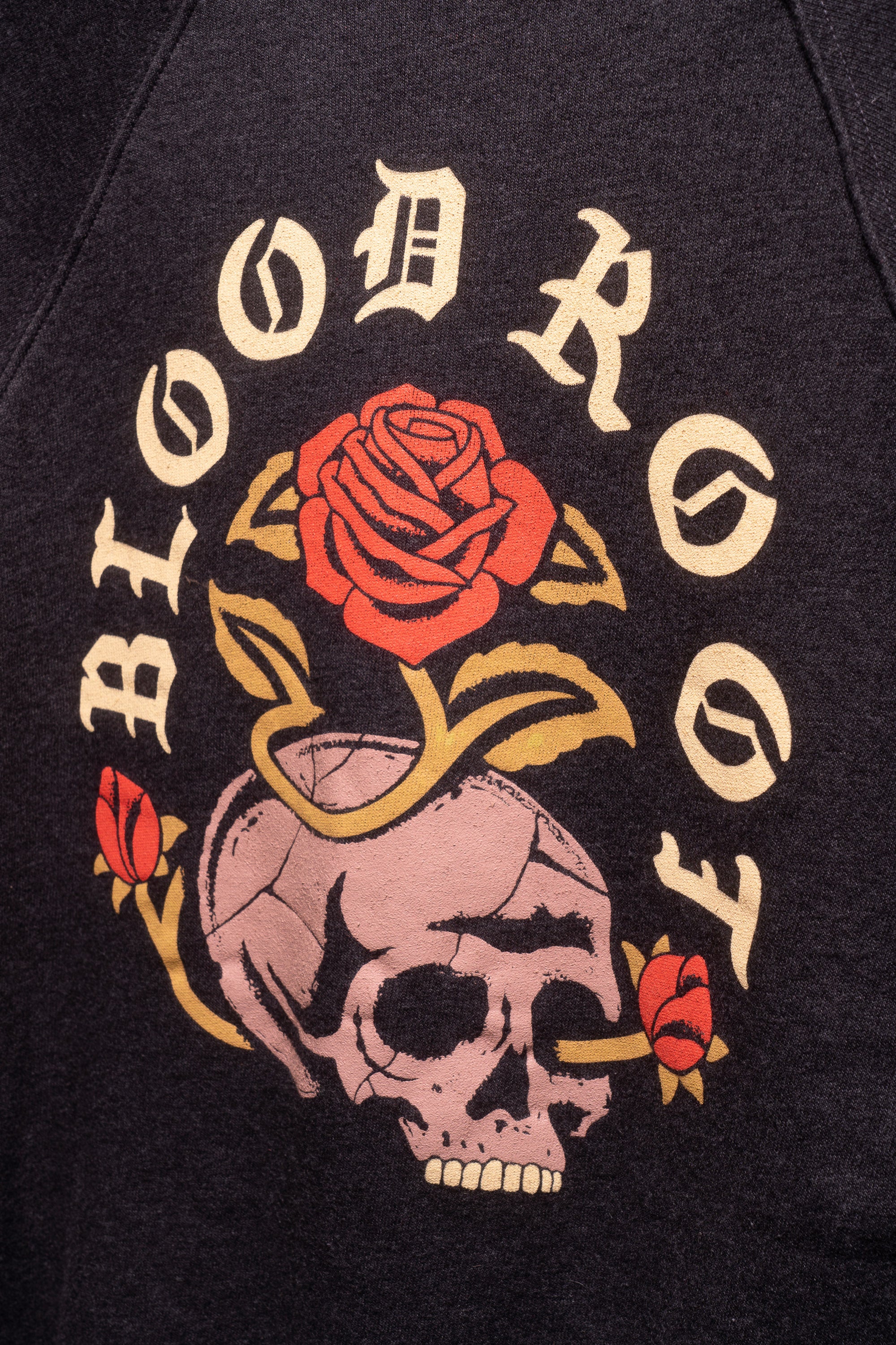 Close view of skull and roses design with BloodRoot name