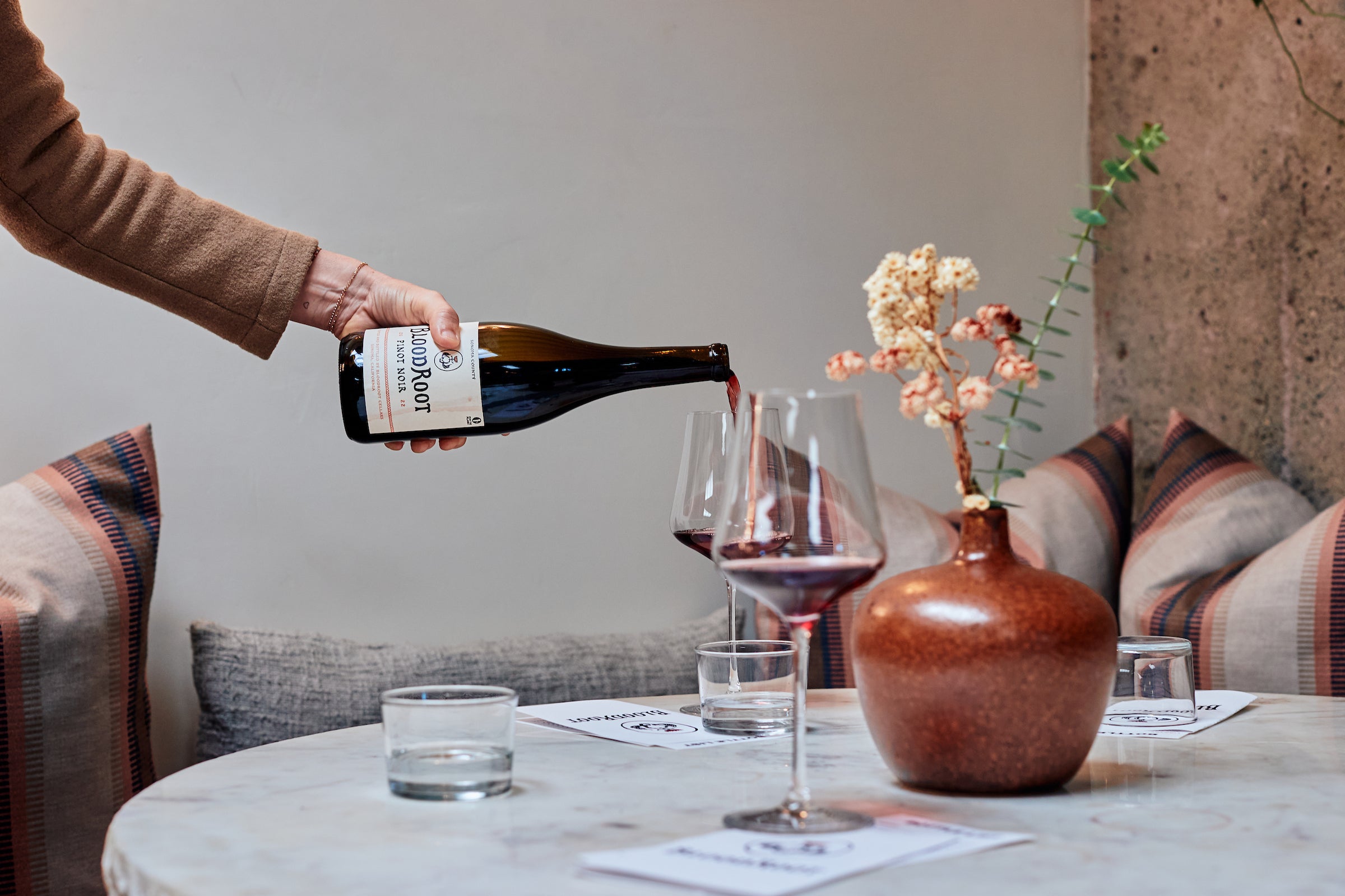 BloodRoot Pinot Noir is poured into a glass at the tasting room.