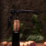 Corkscrew taking out BloodRoot cork from bottle of wine