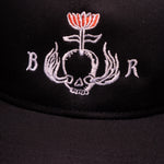 Zoomed in view of white BloodRoot logo variation on black hat