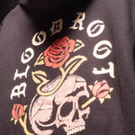 Close up view of BloodRoot Skull and Roses design on the back of black hoodie