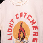 Close up view of light catchers logo on white t-shirt