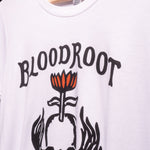 Zoomed in view of black BloodRoot logo on white t-shirt