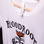 Front view of white BloodRoot t-shirt with black logo featuring Bella Canvas tag